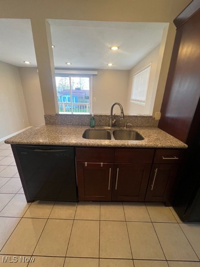 Eat-In Kitchen featuring dishwasher, sink, and light tile flooring | Image 14