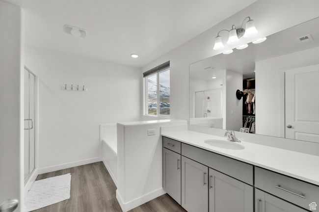 Bathroom with vanity, a stall shower, visible vents, and wood finished floors | Image 14