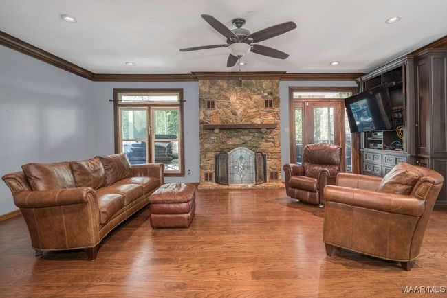A focal point in the Greatroom is a stone fireplace. Plus there's a built-in entertainment center. | Image 19