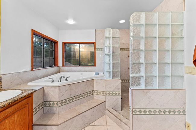 Full bathroom with a garden tub, vanity, tile patterned floors, and walk in shower | Image 30