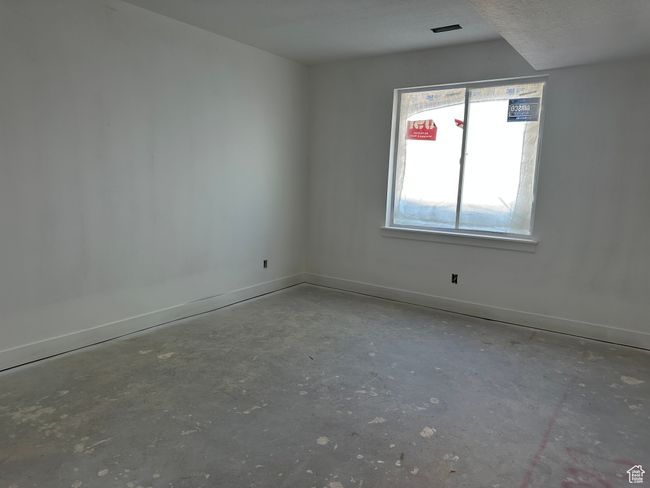 Empty room with unfinished concrete flooring and baseboards | Image 29