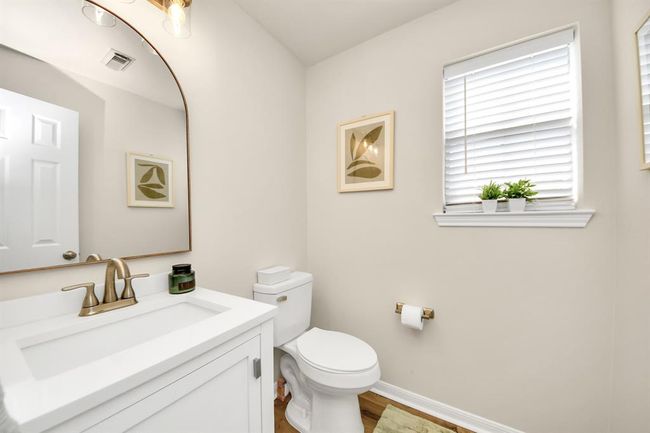 This handy half bath on the first floor sits right between key areas of the home, providing comfort and convenience for guests and family. | Image 10