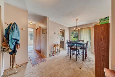 Dining area featuring light carpet and a notable chandelier | Image 2