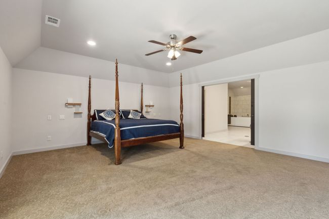 Carpeted bedroom with ensuite bath and ceiling fan | Image 21