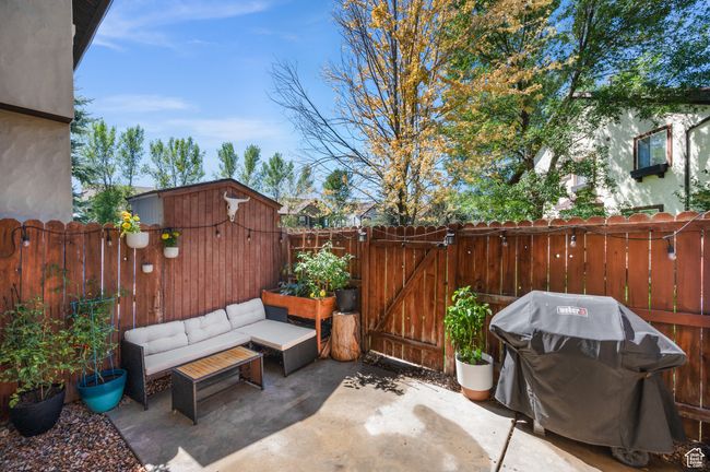 Fenced backyard featuring a patio, area for grilling, and a gate | Image 23