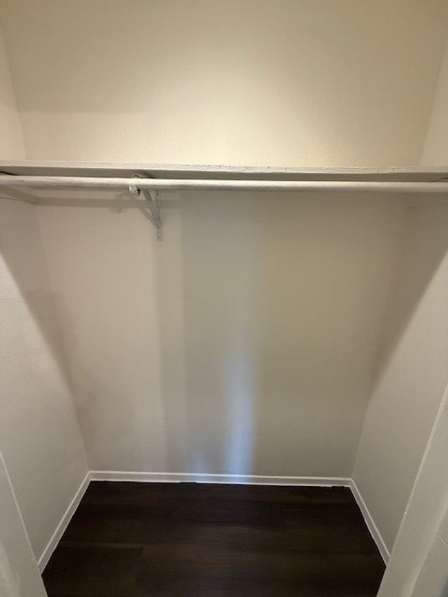 Spacious closet featuring dark wood finished floors | Image 7