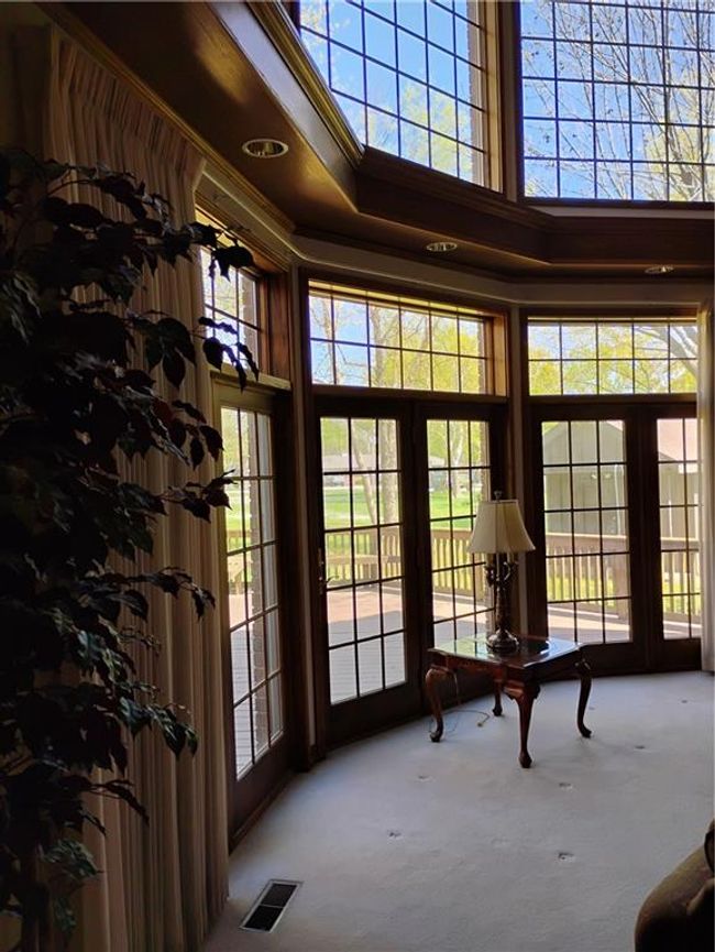 Doorway with a healthy amount of sunlight, a towering ceiling, visible vents, and carpet | Image 24