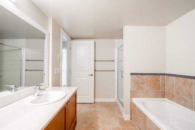 Full bathroom with a shower stall, a garden tub, and vanity | Image 14