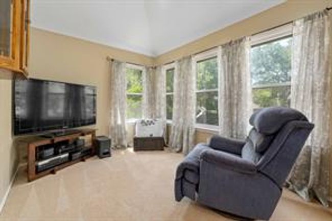 Carpeted living area featuring lofted ceiling | Image 25