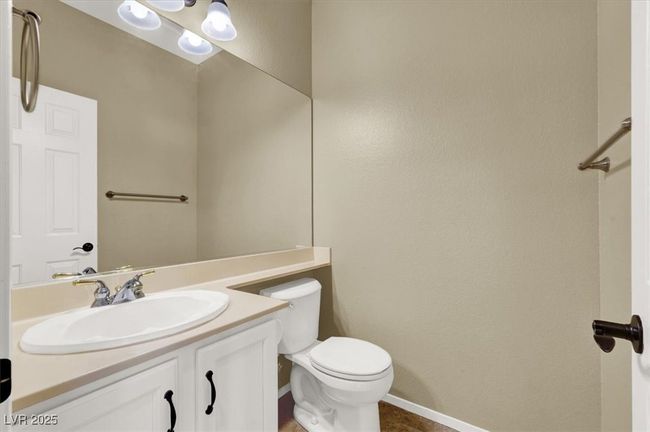 Half bathroom featuring toilet and vanity | Image 21