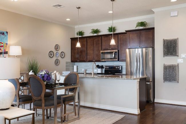 2nd Floor Kitchen with tasteful backsplash, visible vents, appliances with stainless steel finishes, dark wood-style flooring, and dark brown cabinets | Image 12