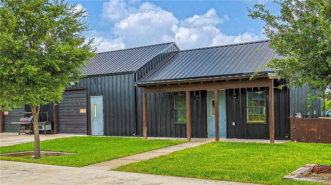 View of front of barndominium (3, 000sqft) featuring a front yard and a metal roof | Image 39