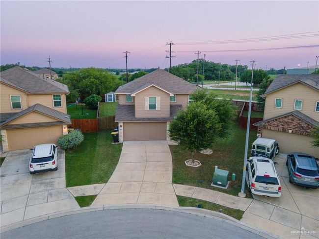 Traditional-style home featuring concrete driveway, a garage, and a shingled roof | Image 31