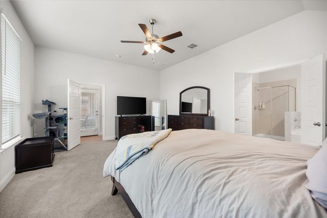 Carpeted bedroom with vaulted ceiling and a ceiling fan | Image 15