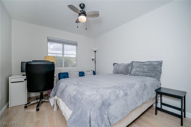 Bedroom featuring wood finished floors, a ceiling fan, and baseboards | Image 17