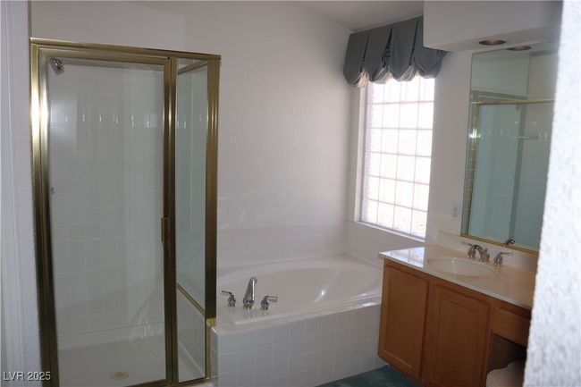 Full bathroom featuring a stall shower, a garden tub, and vanity | Image 46
