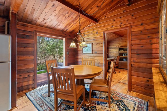 Dining area with hardwood / wood-style flooring and wooden ceiling | Image 13