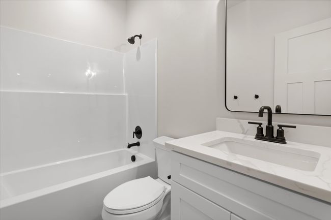 Bathroom featuring vanity, toilet, and shower combination | Image 24