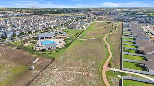 Aerial view of property's location with a pool and nearby suburban area | Image 37