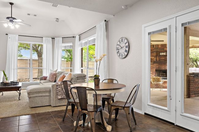 Dining area with a ceiling fan, healthy amount of natural light, and dark tile patterned floors | Image 16