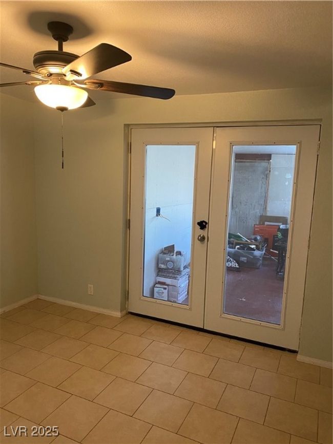 Doorway featuring light tile patterned flooring, french doors, ceiling fan, and baseboards | Image 12