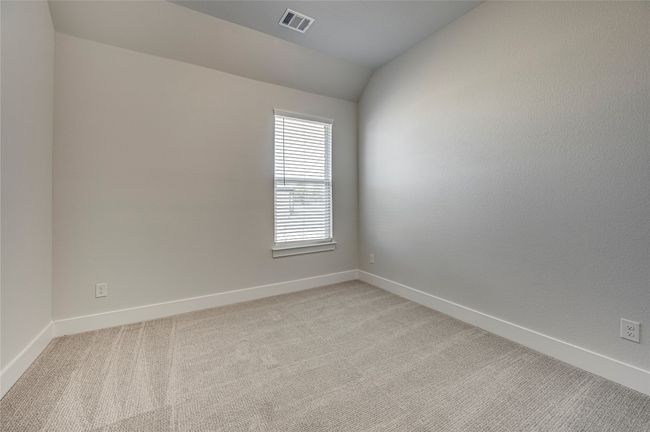 Empty room with visible vents, light colored carpet, baseboards, and lofted ceiling | Image 26