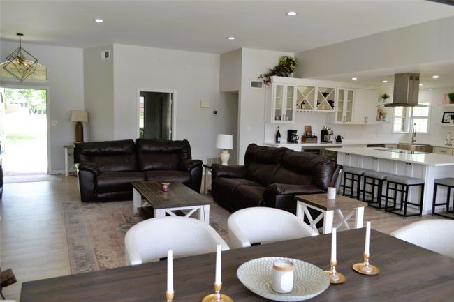 Living room featuring healthy amount of natural light, recessed lighting, and light wood-style floors | Image 6