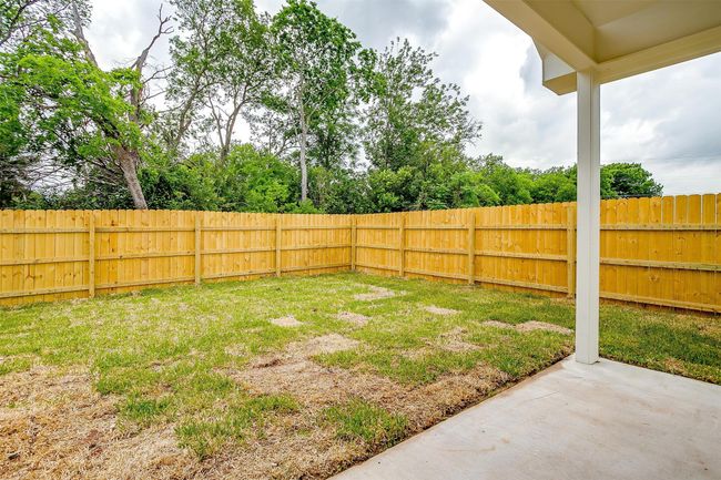 View of yard featuring a fenced backyard and a patio area | Image 32
