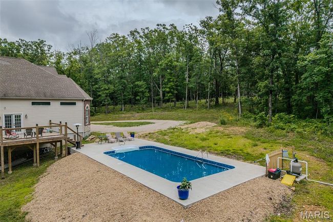 Swimming pool with a wooden deck and a patio | Image 64