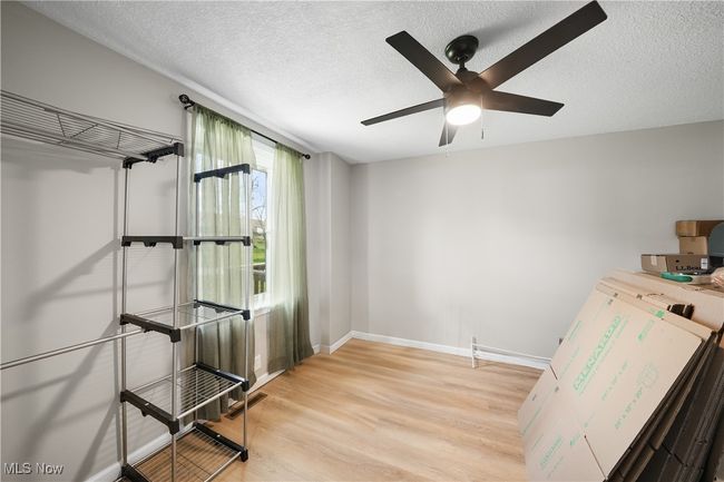 Storage room with ceiling fan | Image 17