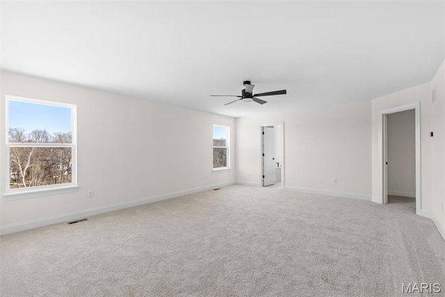 Unfurnished room with ceiling fan and light carpet | Image 7