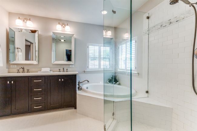 Bathroom featuring a separate shower, double vanity, and a garden tub | Image 19
