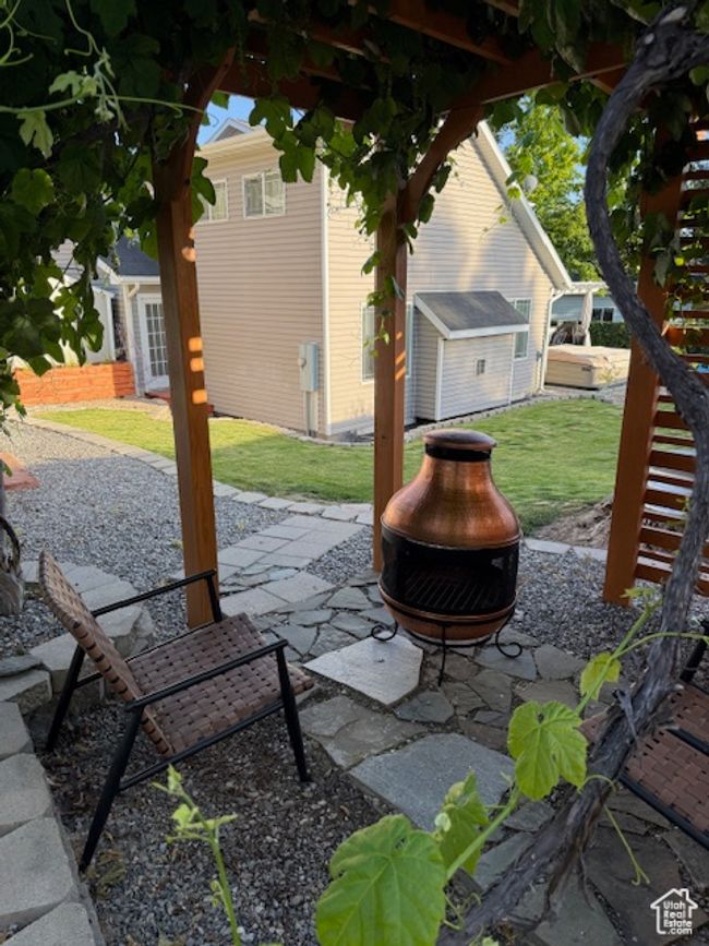 View of patio featuring an outdoor fire pit | Image 44