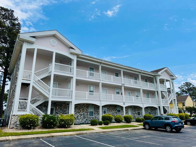 View of property featuring uncovered parking and stairway | Image 35