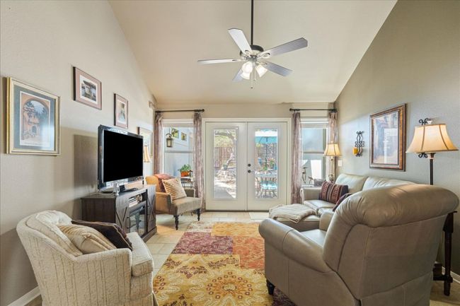 Living room featuring french doors, ceiling fan, lofted ceiling, and light tile patterned floors | Image 14