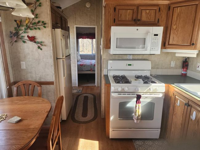 Kitchen and Dining Area showing hall and bedroom in the distance. | Image 14