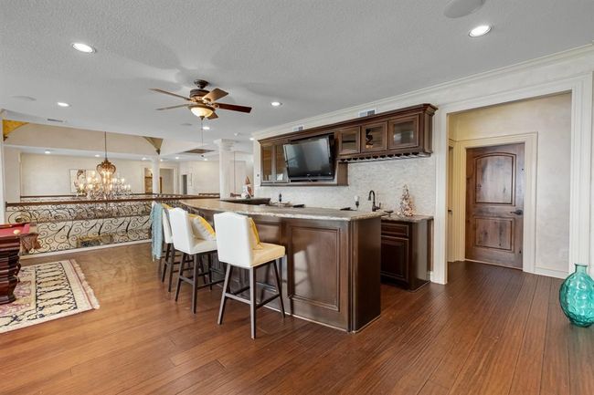 wet bar with sink, ice maker, and mini fridge on 2nd level next to gameroom | Image 41