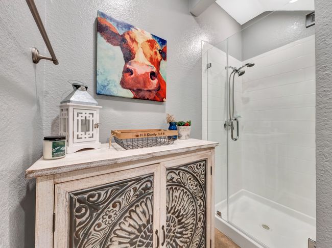 Bathroom with a stall shower and a textured wall | Image 33