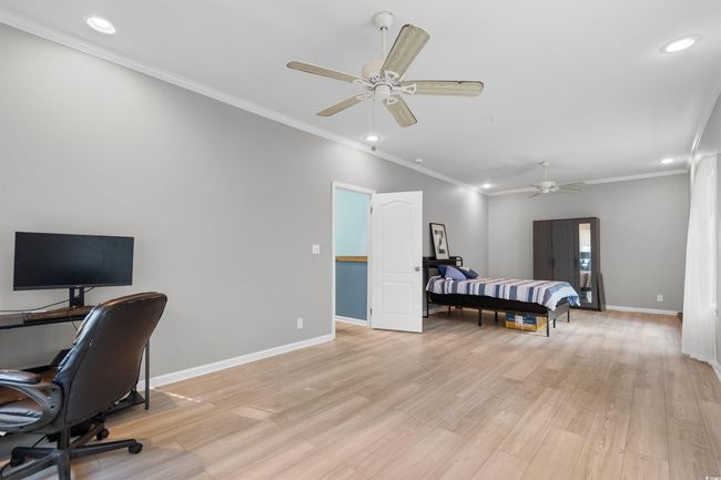 Bedroom featuring recessed lighting, light wood-type flooring, baseboards, an office area, and crown molding | Image 23