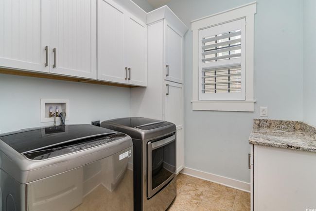 Laundry room featuring baseboards, washer and dryer, and cabinet space | Image 16