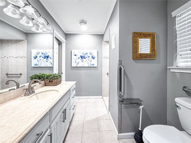Full bath with ornamental molding, a textured wall, tile patterned flooring, vanity, and a shower | Image 36