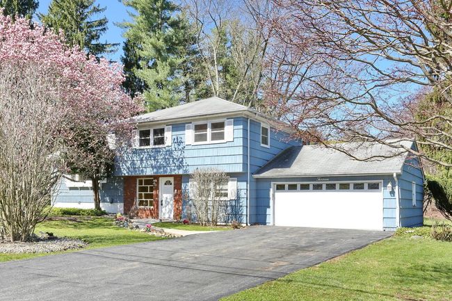 Colonial-style house with driveway, a front yard, and a garage | Image 30