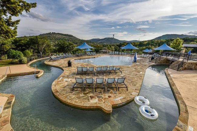 Community pool with a mountain view and a patio area | Image 23
