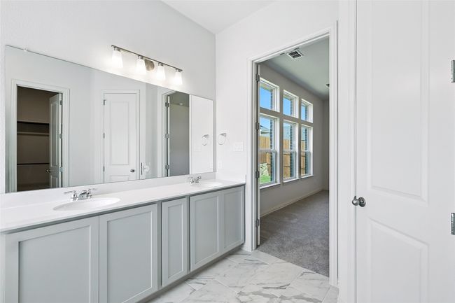 Full bath with double vanity and marble look tiles | Image 23