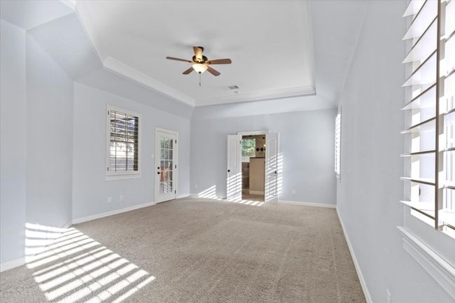 The primary suite is incredibly spacious, with high ceilings, plenty of room for a seating area, a walk-in closet, and an equally spacious ensuite. | Image 17