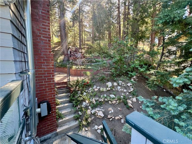 Stairs from living room deck area to side yard. | Image 32