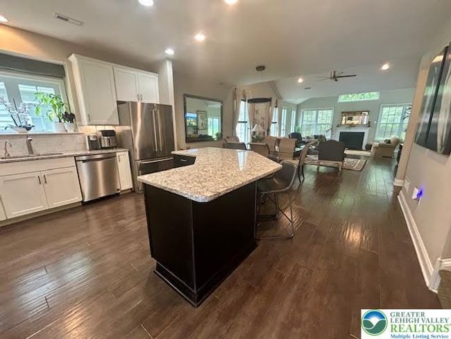 Grand entry from foyer into kitche, dining area, and extended great room | Image 9