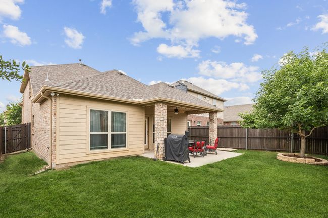 Rear view of property with brick siding, roof with shingles, ceiling fan, and a patio area | Image 26