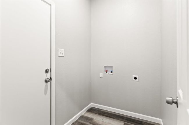 Washroom featuring hookup for an electric dryer, hookup for a washing machine, and hardwood / wood-style floors | Image 25