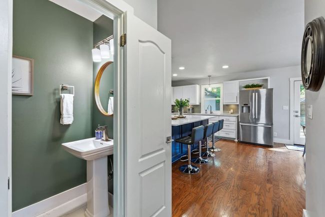 Office featuring dark wood-type flooring and recessed lighting | Image 7